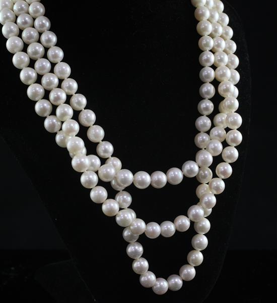 A modern triple strand cultured pearl necklace with 18ct gold, diamond and cultured pearl set oval clasp, 17.5in.